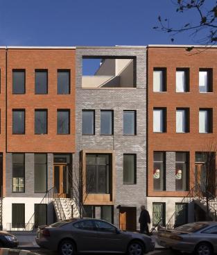 The architects skillfully played with shadows and sunlight on the projects street facade, emphasizing its deep window recesses, copper bays, and top-floor cutouts. Variously colored sand-cast brick possesses a light-catching texture.