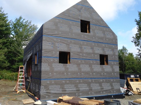 Figure 11. We lapped the Humida WRB down over the first-floor framing and foundation, down to the stone shelf, sealing all seams and fastener locations with Tescon Vana tape.