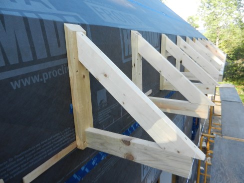 Figure 12. We built eaves brackets from 2-by stock on the ground and installed them outside of the building envelope.