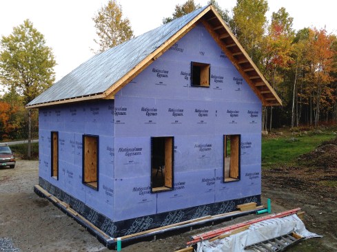 Figure 16. The Gold Bond sheathing is moisture and mold resistant and is vapor-open. It helps resist racking and it protected the Humida WRB against UV and the elements while the fieldstone veneer was slowly pieced together. Grace Ice and Water Shield covered the stone shelf, joining the WRB and drainage mat together. The finish roofing was installed (see illustration, above).