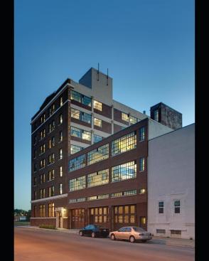The restoration highlights the 1911 buildings history as a utilitarian commercial space.