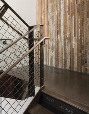 The mild steel clad entryway of the old building, a former shoe parts warehouse, blends with the transitional neighborhood.