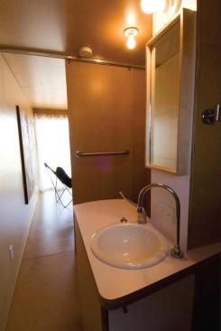 A rear window and swing-open double doors invite cross-ventilation through the MDF-wrapped interiors.