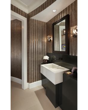 The underground level of this house needed a complete renovation with finishes that would make it an appropriate place for throwing dinner parties and charity events. Corrugated steel walls add a sculptural feel to the powder room. Despite its being an industrial material, the steel actually looks elegant next to the more traditional finishes. Project: Franklin Residence, Franklin, Mich.; Architect: Robert Clarke, CBi Design Professionals, Inc., Bloomfield Hills, Mich.; Builder: Dan Sebold, Thomas Sebold & Associates, Bloomfield Hills, Mich.; Interior Designer: Jennifer Gilbert, Doodle Home, Livonia, Mich.