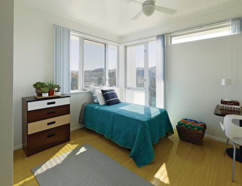 The robust materiality of the public spaces continues in the units themselves, which incorporate highly durable cabinetry, quality furniture, tiled bathrooms, and easy-to-maintain plumbing. Staggered stud walls between units mitigate sound.
