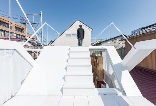 Two ceramic-tiled roof terraces provide outdoor space in the dense urban neighborhood.
