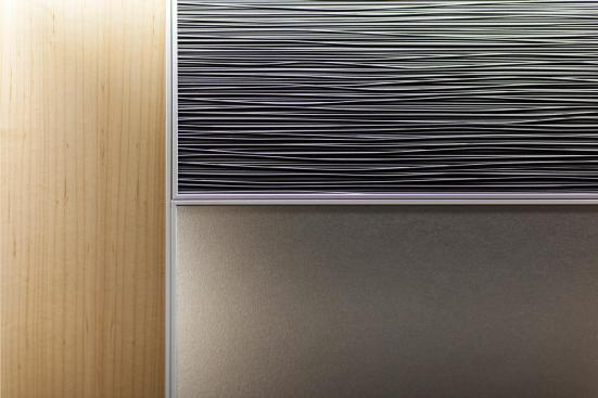 LEVELe-102 Elevator Interior with main panels in Bonded Aluminum with Dark Patina and Grass pattern; large accent panels in Stainless Steel with Sandstone finish; small accent panels in White Birch wood veneer at Florida Hospital Celebration Health, Celebration, Florida