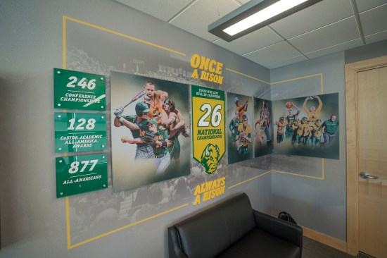 Storytelling wall covering graphics integrate the program’s brand into the space