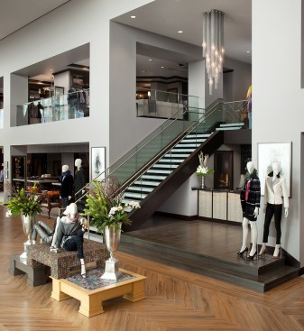 Marble staircase to upper level with client refreshment bar