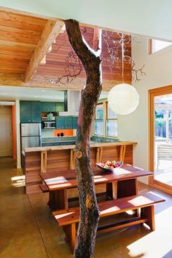 The scale of the double-height dining room is accentuated with a madrone tree column, found by the owners on a friend’s nearby property.
