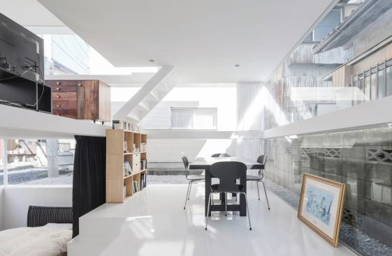 Dining area with view down to bedroom and up to living room.
