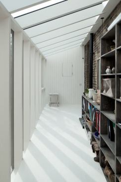 Glass-enclosed ramp connecting to two weavers' cottages and leading down to the new addition.