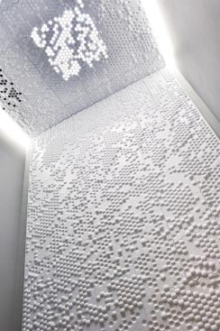 The patterning of the panels was customized to the needs of this particular bathroom application. The ceiling fan vent and skylight, for example, are accommodated by perforated panels?an adaptive characteristic that piqued the jury's interest