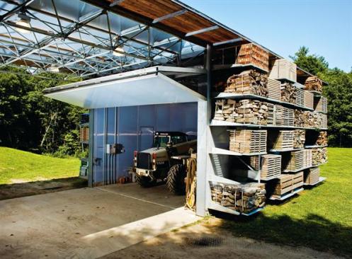 The building was designed around the proportions of the 4-foot-wide pallets and around the turning radius and width of the loader used to move them. A bi-fold door can close to keep the loader secure and out of the elements.
