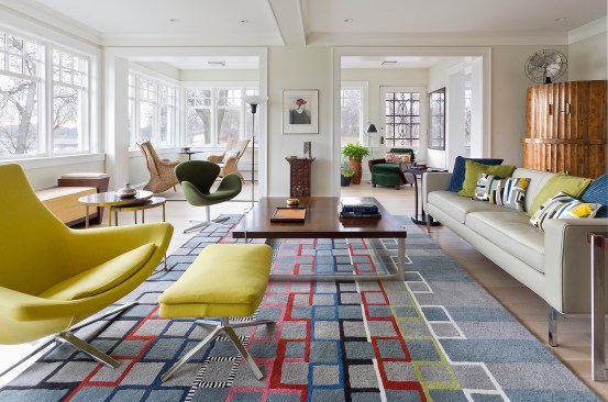 White living room with lots of windows and colorful rug and accents