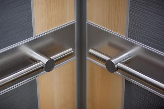 LEVELe-102 Elevator Interior with main panels in Bonded Aluminum with Dark Patina and Grass pattern; small accent panels in White Birch wood veneer; handrail panels in Stainless Steel with Sandstone finish; Compass handrails in Satin Stainless Steel at Florida Hospital Celebration Health, Celebration, Florida