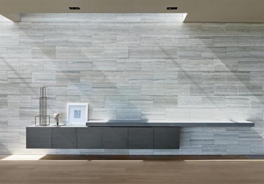 The silver travertine entry wall slips through the front door, continuing into the living area.