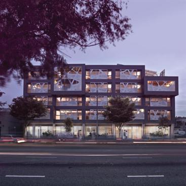 Dynamically patterned metal screens on the front elevation help the project assert itself on a wide, well-trafficked boulevard.