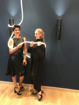 Pallavi Dean (left) and friend with one of the Interweave lighting fixtures Pallavi designed for Artemide.