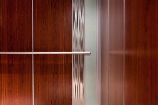 Custom LEVELe-101 Elevator Interior with custom main inset panels; outer accent panels in ViviChrome Chromis glass with Mirror Mist interlayer and Opalex finish; inner accent panels in Stainless Steel with Seastone finish and Kalahari pattern at MIT - Massachusetts Institute of Technology, Cambridge, Massachusetts