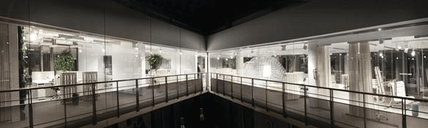 The+fifth-floor+atrium+of+the+base+building+offers+a+panoramic+view+of+the+open-plan+office%2c+including+the+two+additional+bubbles+that+are+used+as+conference+space.