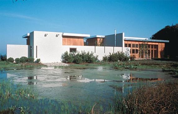 The concrete wall defining the eastern elevation shields a guest suite and courtyard from adjacent marshland.