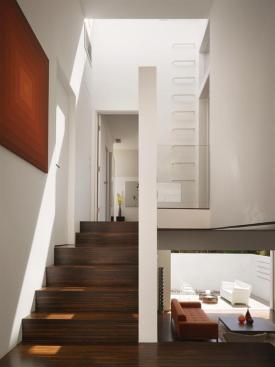 A ships ladder at the top of stairs provides access to the home's rooftop deck.