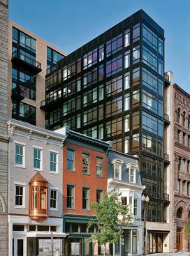Maintaining the scale of its traditional neighbors, this modern building promotes social interaction with floor-to-ceiling glass windows and Europeanstyle balconies.