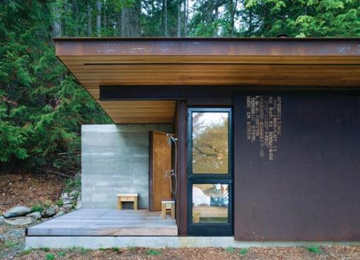 The sliding door also closes partway for privacy. A wood stove provides heat, and a propane tank supplies on demand hot water. 