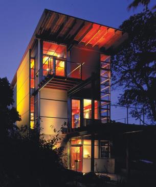 A steel spine expresses the homes structure inside and out, extending through the rear facade to support two decks.