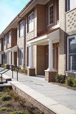 Village Green’s elevated sidewalk – designed to meet accessibility requirements for disabled residents and guests – functions similarly to traditional neighborhood stoops.