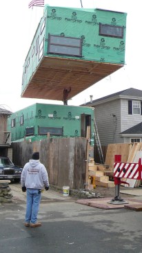 Prefab modules being set by crane.