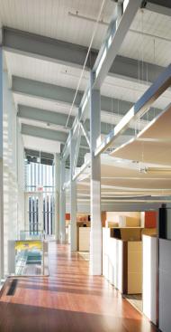 On the second floor, high ceilings and floor-to-ceiling windows afford views of the outdoors, one benefit of going through the site-remediation process. Despite the cost of the cleanup, as well as the rich hardwood detailing throughout the building, the cost was a modest $220 per square foot-or $80 below comparable area projects.