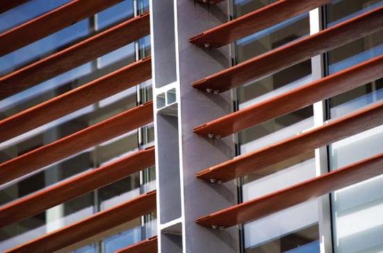 Metal spacers delineate window bays while also providing an anchor point for window-washing platforms to be affixed to the side of the building.