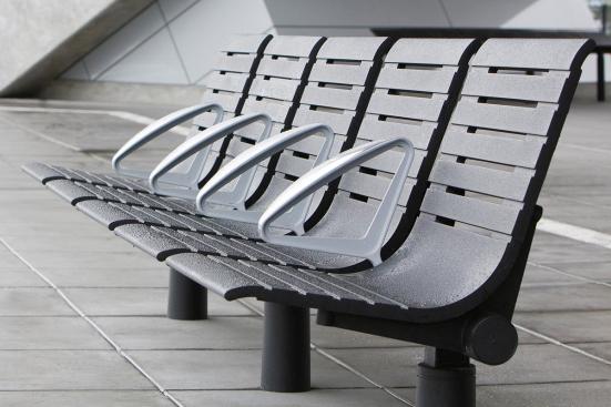Tecno RS Seating System shown in five-seat, backed configuration with Black Texture powdercoated frame and seats, Silver Texture powdercoated angled armrests, and cylindrical mounting posts at Sound Transit, Seattle, Washington
