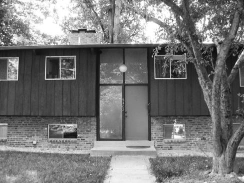 Before: The home’s façade showed its age from the globe porch light to the painted wood siding.