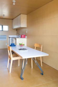 A rear window and swing-open double doors invite cross-ventilation through the MDF-wrapped interiors.