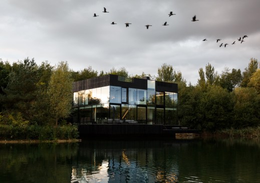 The exterior of the house is designed to disappear/minimally interfere into/with the landscape with the trees, lake and sky reflecting on the glass facades.