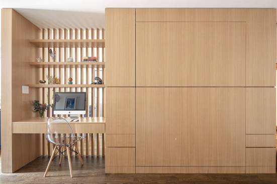 Custom white oak cabinet provides compact home office, murphy bed + storage 