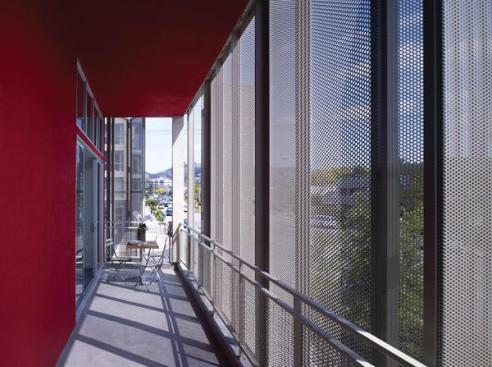 The spaces between the buildings structure and skin serve as private porches.