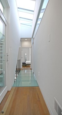 The light-filled and open interiors are courtesy of glass floors, large windows, and skylights.