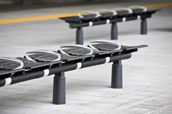 Tecno RS Seating System shown in five-seat, backless configuration with Black Texture powdercoated frame and seats, Silver Texture powdercoated low-profile horizontal armrests with polished upper surfaces, and cylindrical mounting posts at Sound Transit, Seattle, Washington