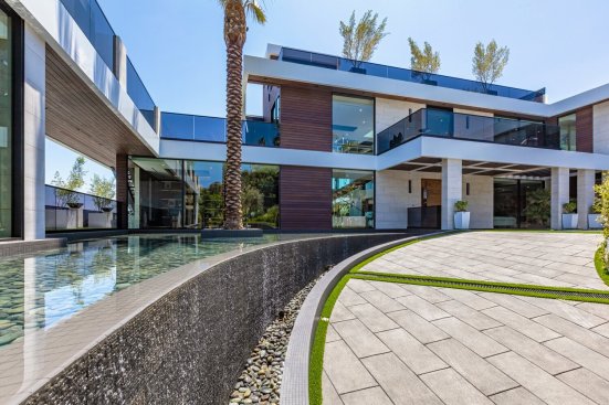Modern luxury Los Angeles home with entrance pond and waterfall.