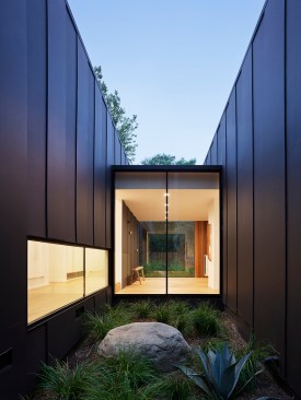 Glass hallway connecting living and sleeping pavilions 