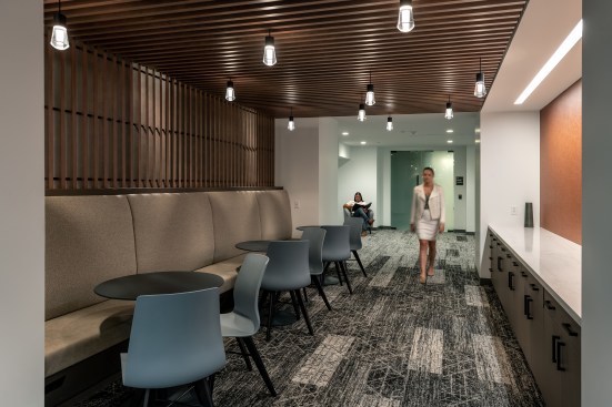 The working lounge has a custom banquet that contains power within an angled base.