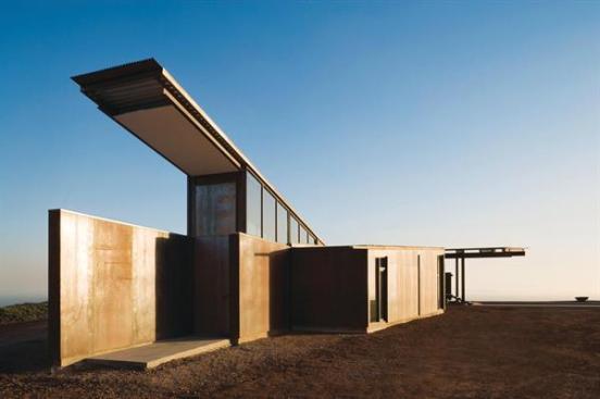 Guest rooms and the pool lie on one side of the spine, garage and private areas on the other.