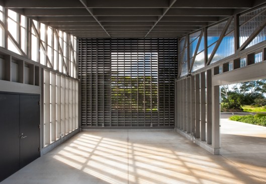 The interior of the education pavilion is defined at the front by fiber cement slats spaced apart to enhance natural ventilation, and corrugated polycarbonate panels at the sides for protection from rain
