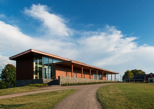The campus side offers a one-story structure with a long welcoming porch.