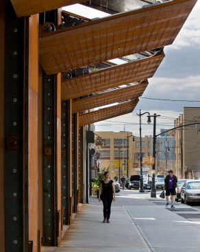 The perforated Cor-Ten steel panels act as awnings during the day.