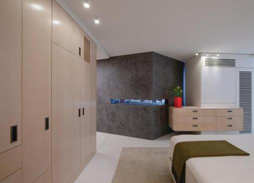An electrostatic glass ribbon in the V-shaped wall can go opaque or clear, giving a sense of the space beyond